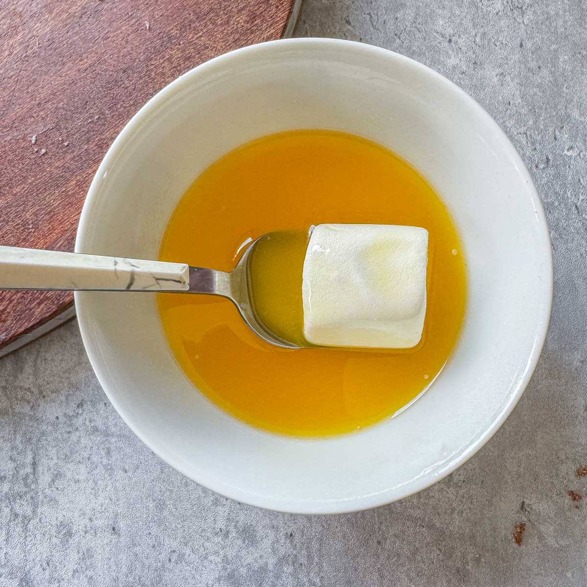 marshmallow beting rolled in a bowl of butter.