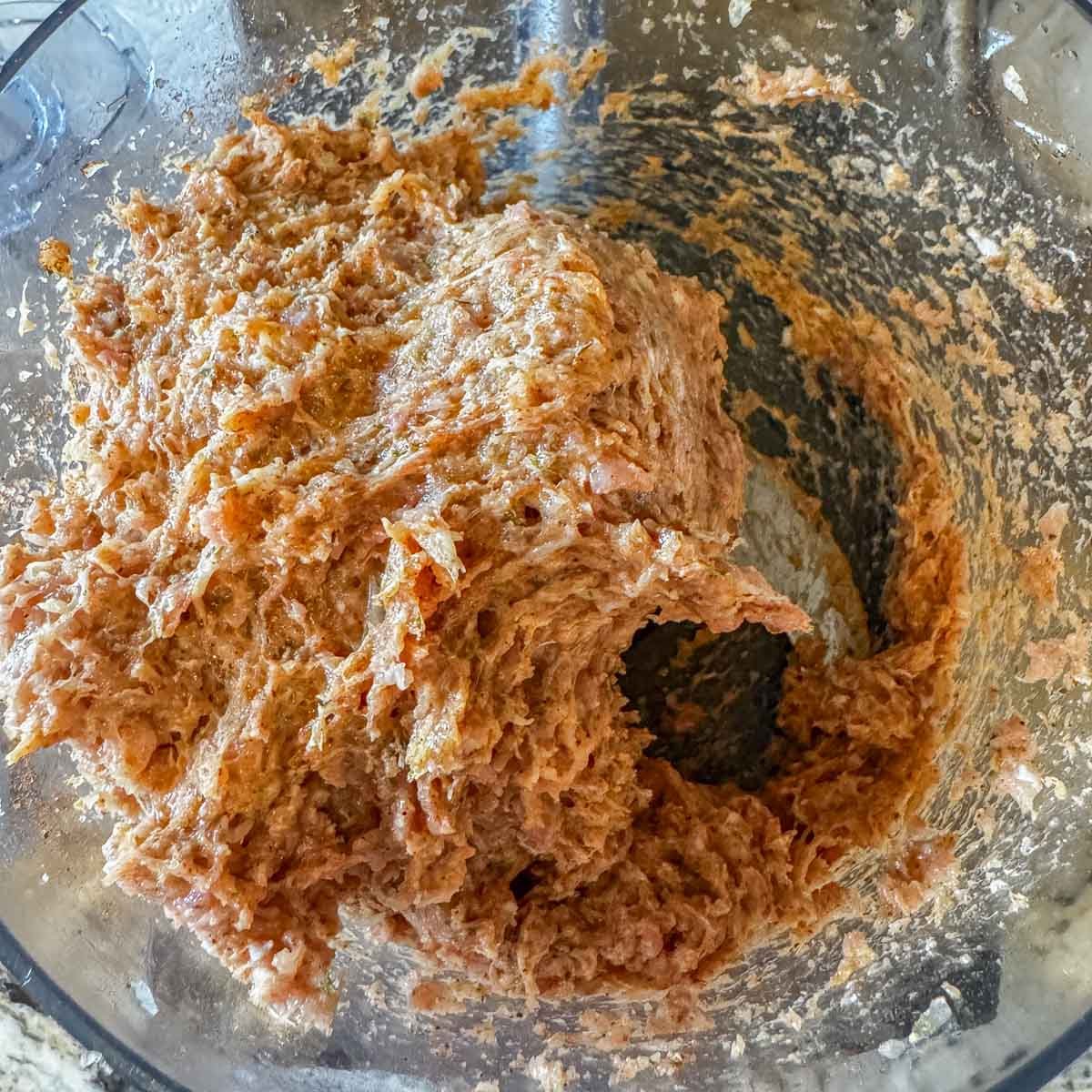 chicken gyro mixture in a foo processor bowl.