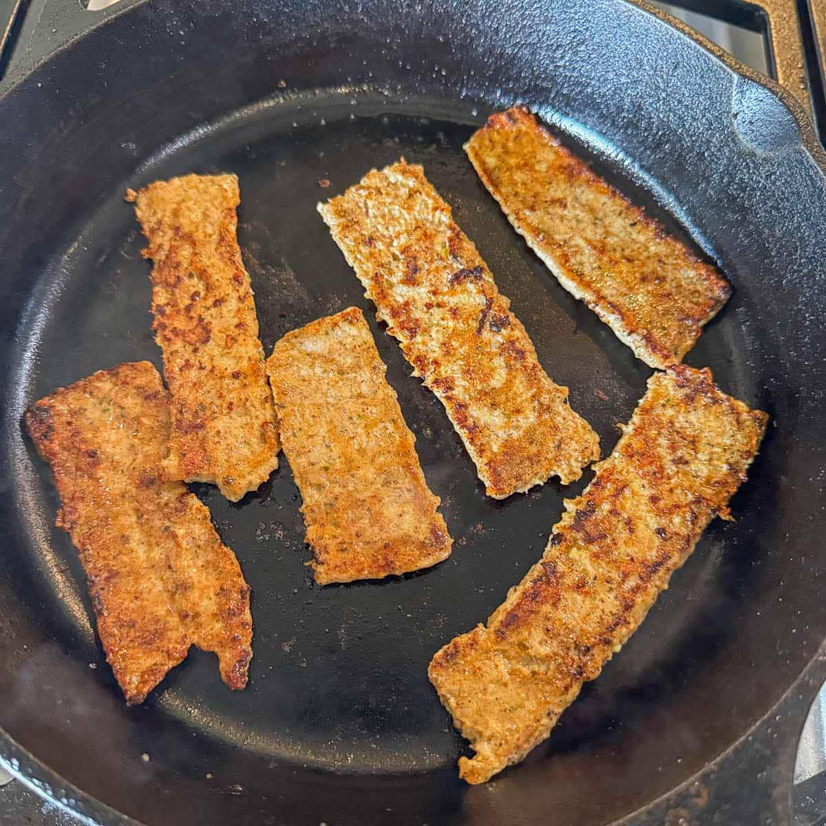 chicken gyros cooking in a pan.