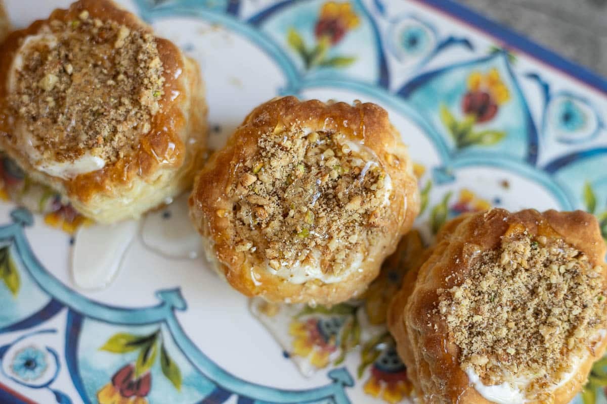baklava cheesecake puff pastry shells on a pretty platter.