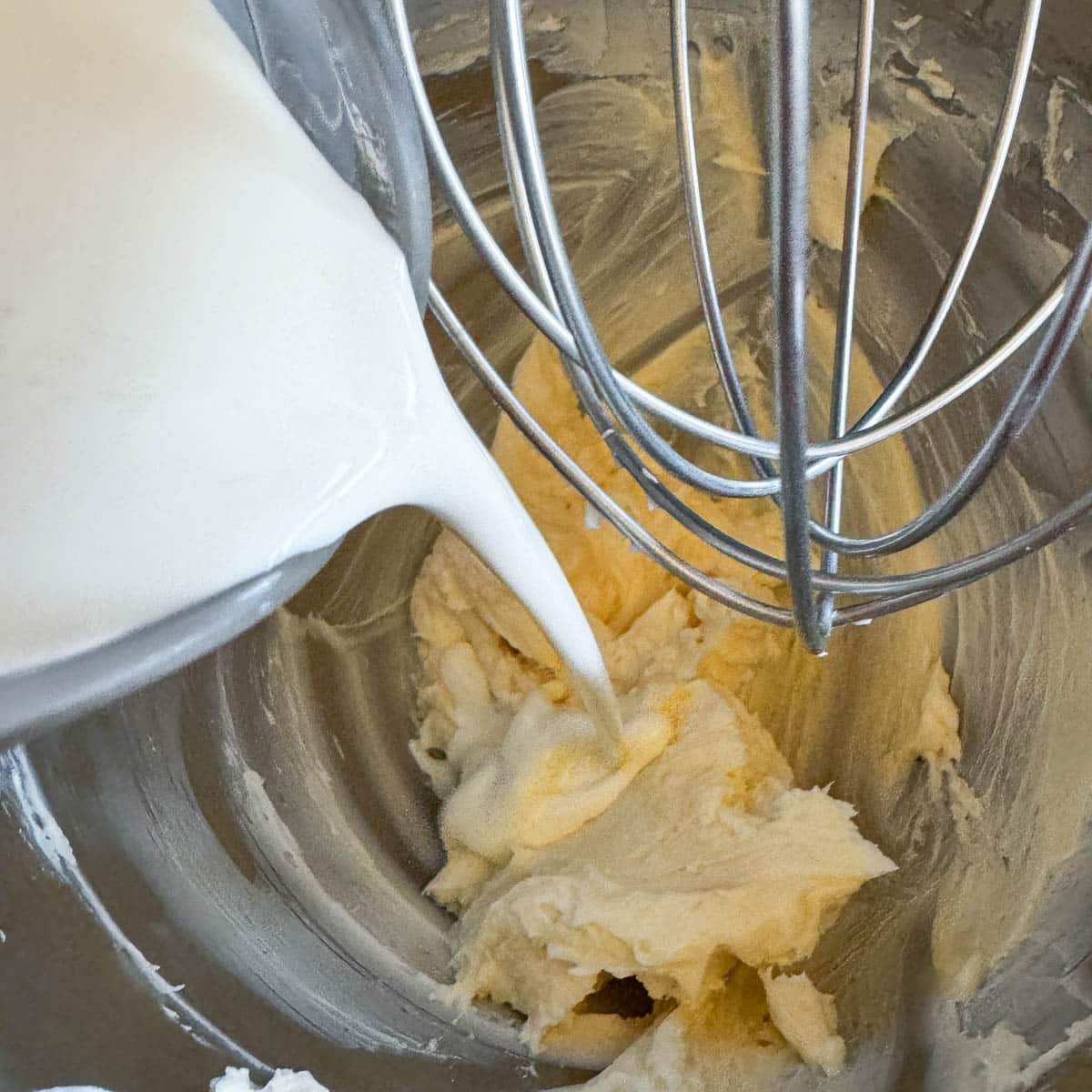 adding heavy whipping cream to cheesecake batter.