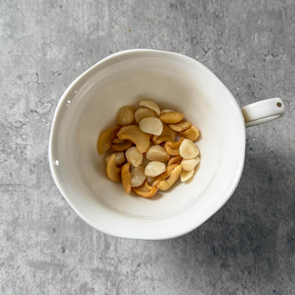 cashews and macadamia nuts in teacup.