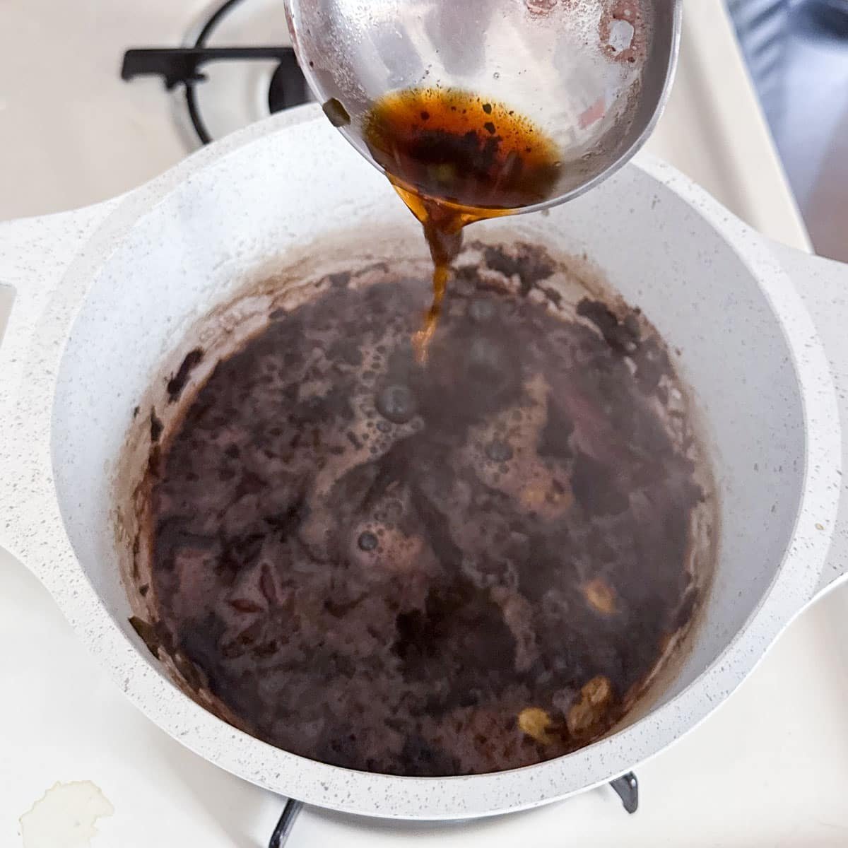 ladle aerating the kashmiri chai.