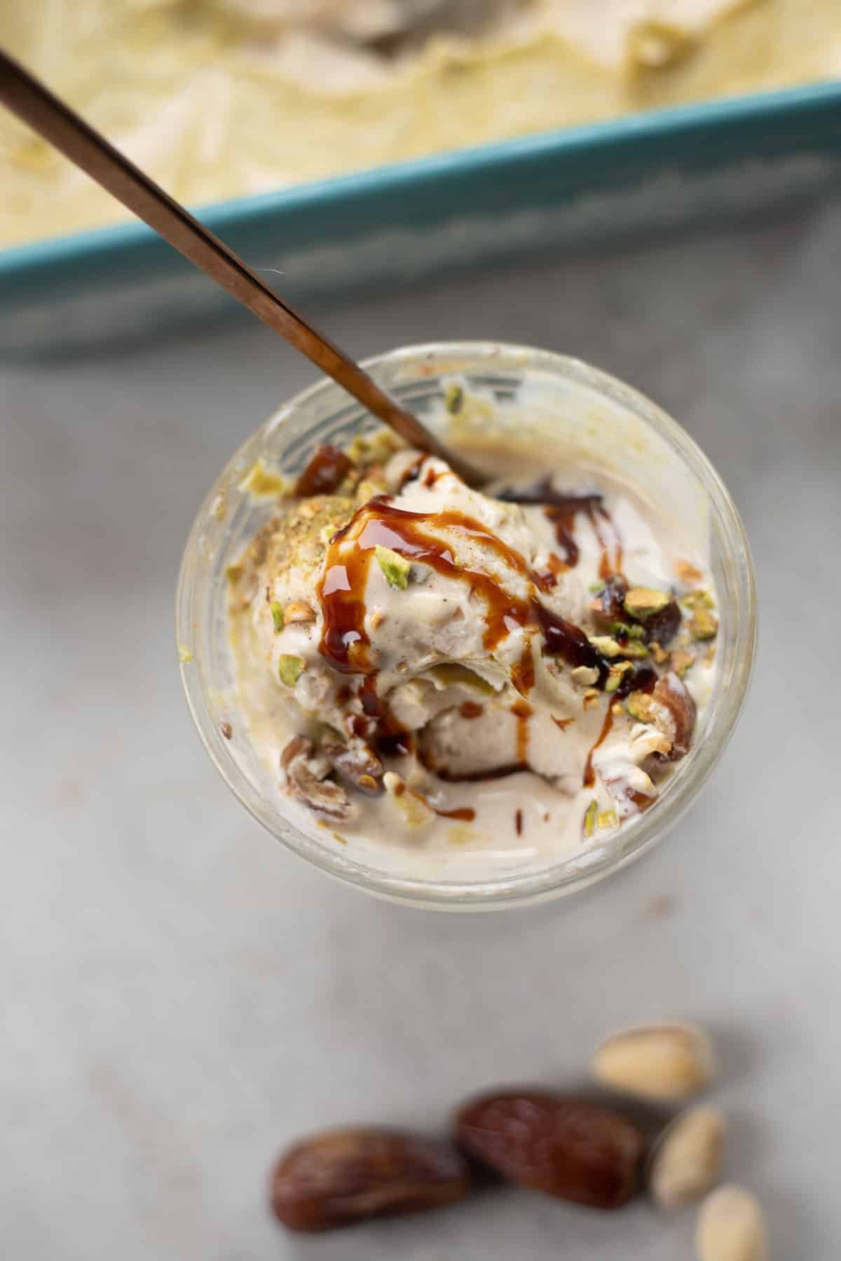 cottage cheese ice cream with date syrup and chopped pistachios.