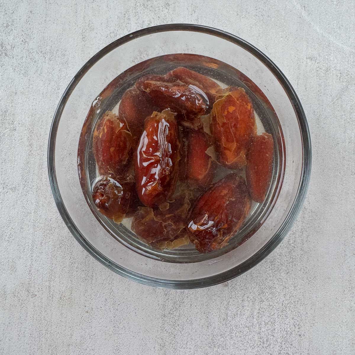 dates soaking in a bowl of water.