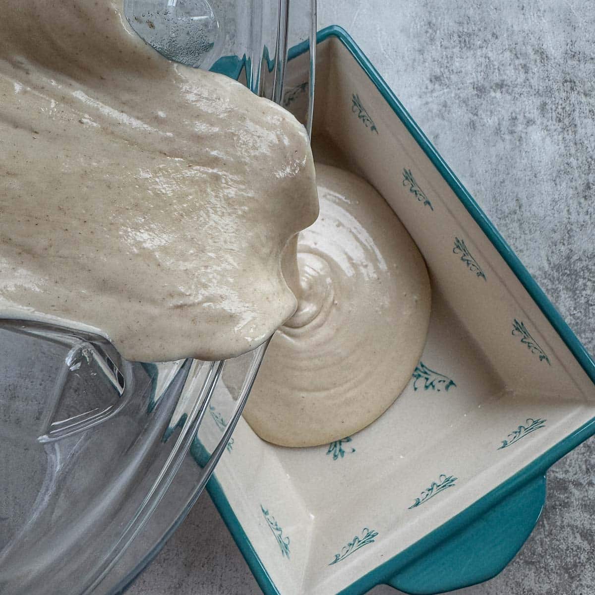 pouring creamy cottage cheese into a dish.