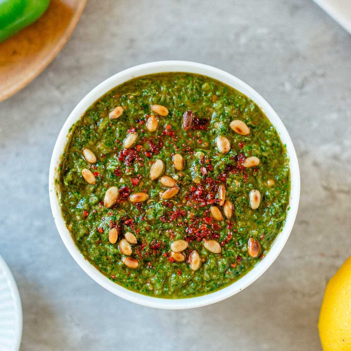 green harissa with pine nuts on top.