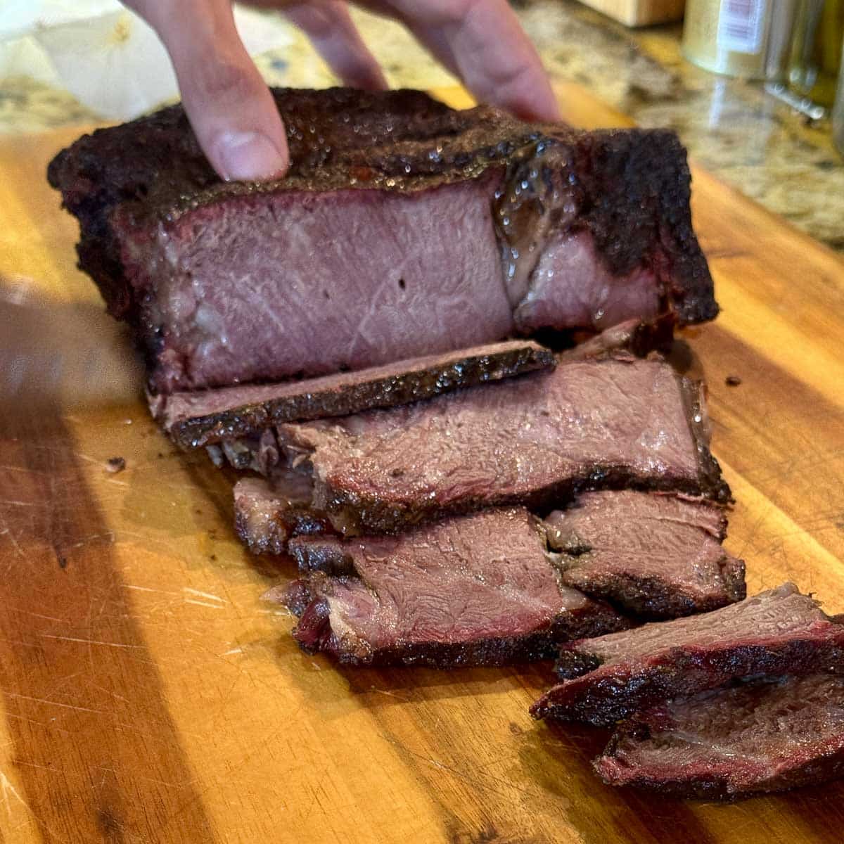 smoked beef roast being sliced. 