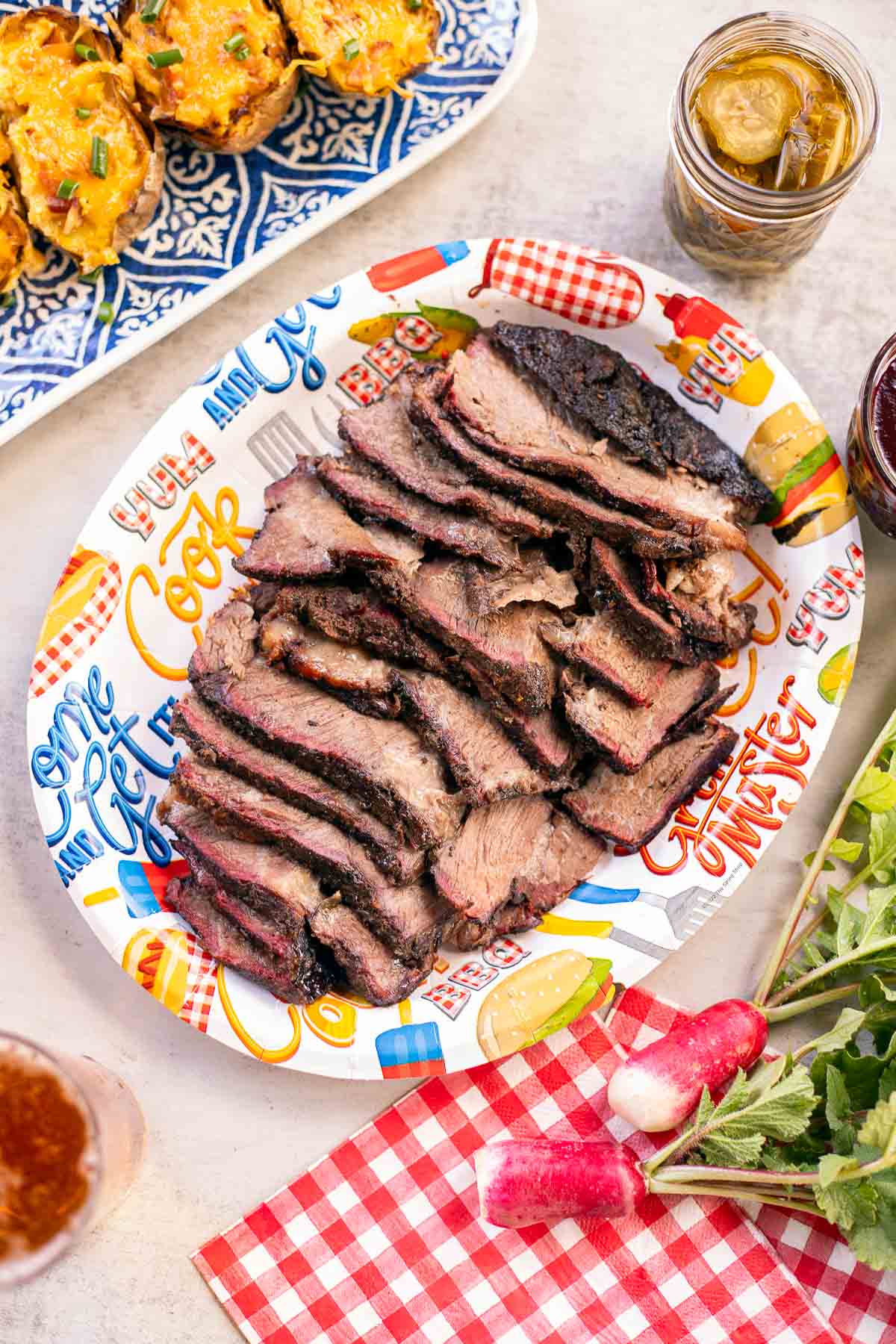 sliced smoked beef roast with potatoes on the side.