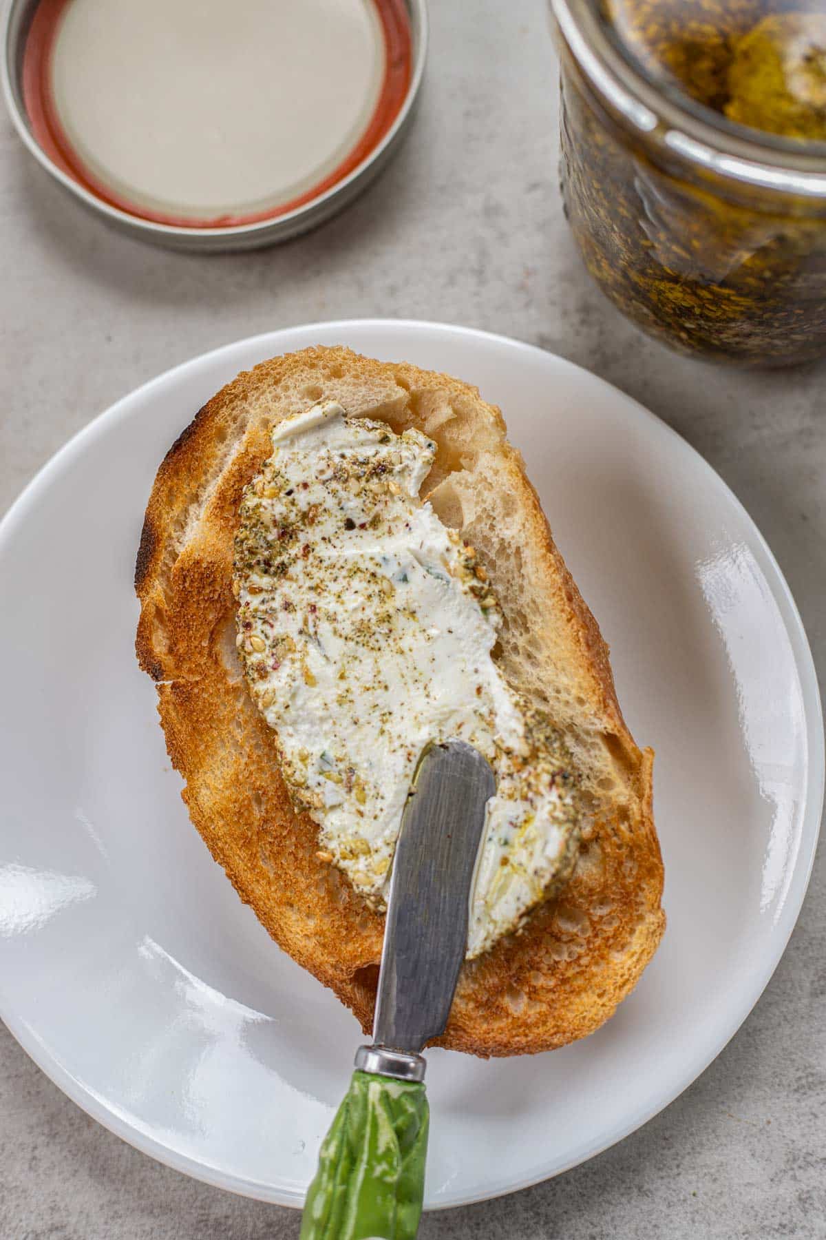 spreading labneh on sourdough.