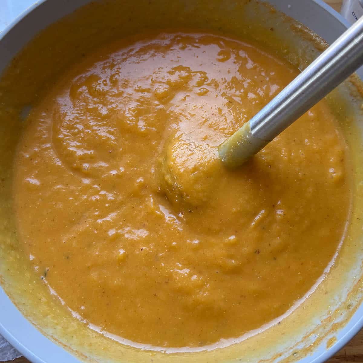 butternut sauce being blended with immersion blender.