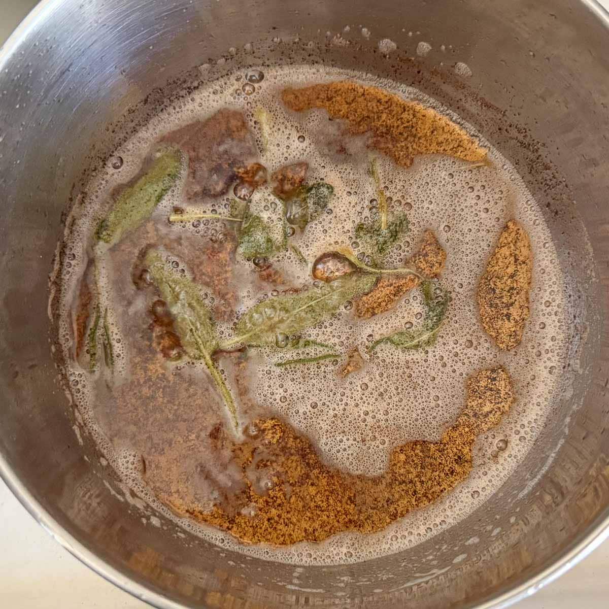 browned butter with sage leaves in pan.