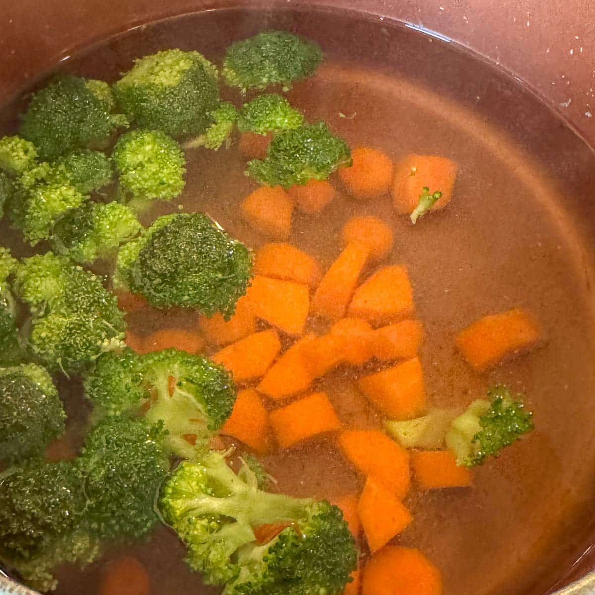 carrots and broccoli in a pot of water. 