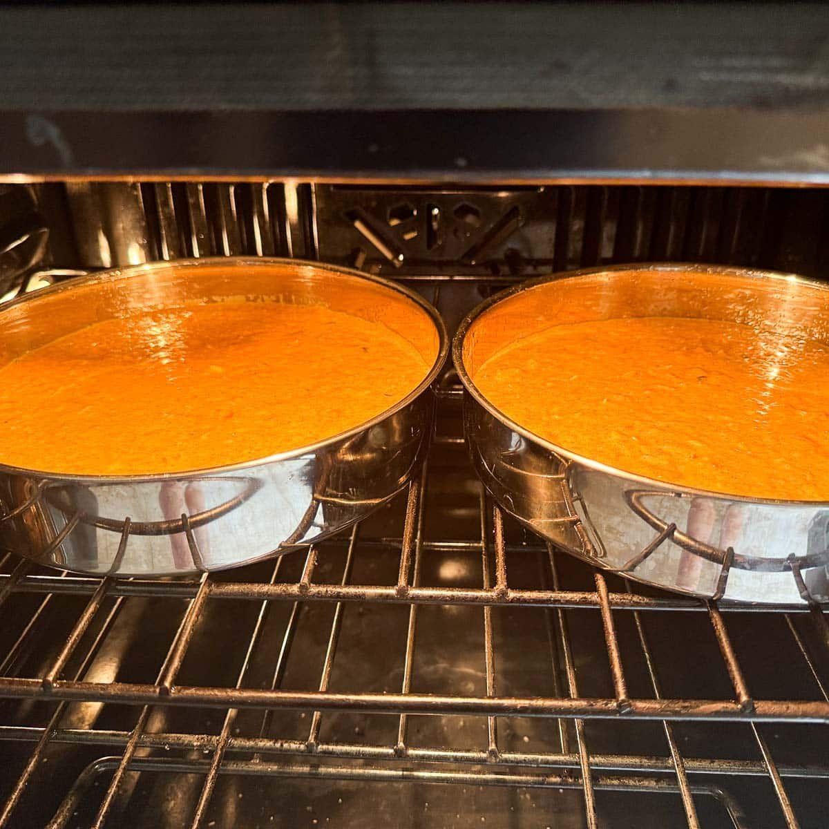 two pans of carrot cake in the oven.