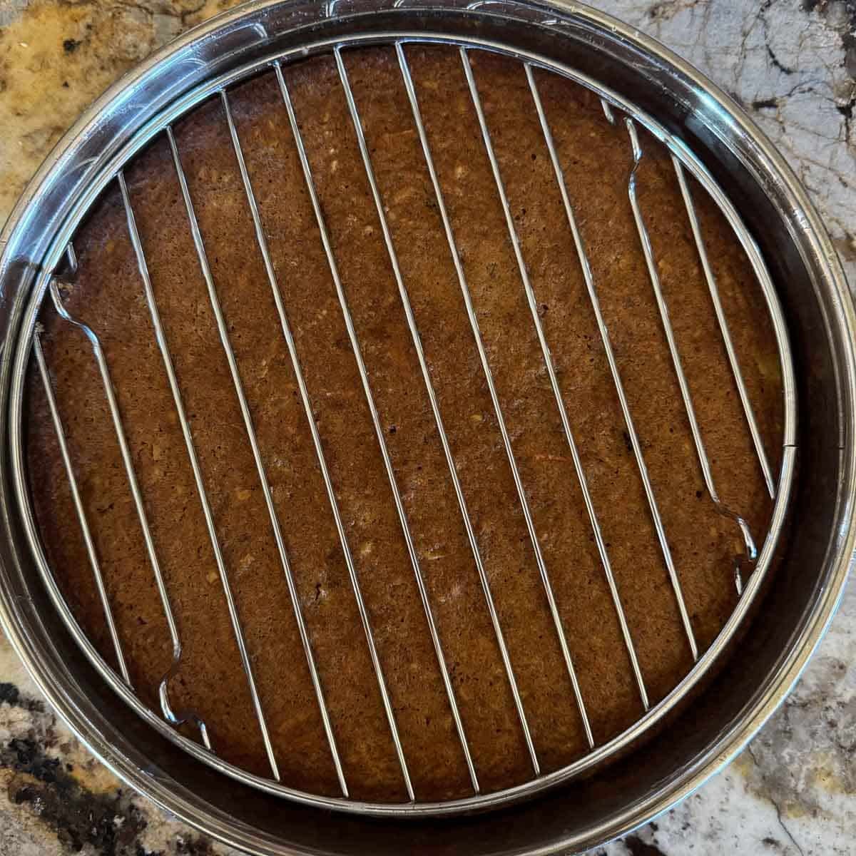 carrot cake with wire rack over it. 