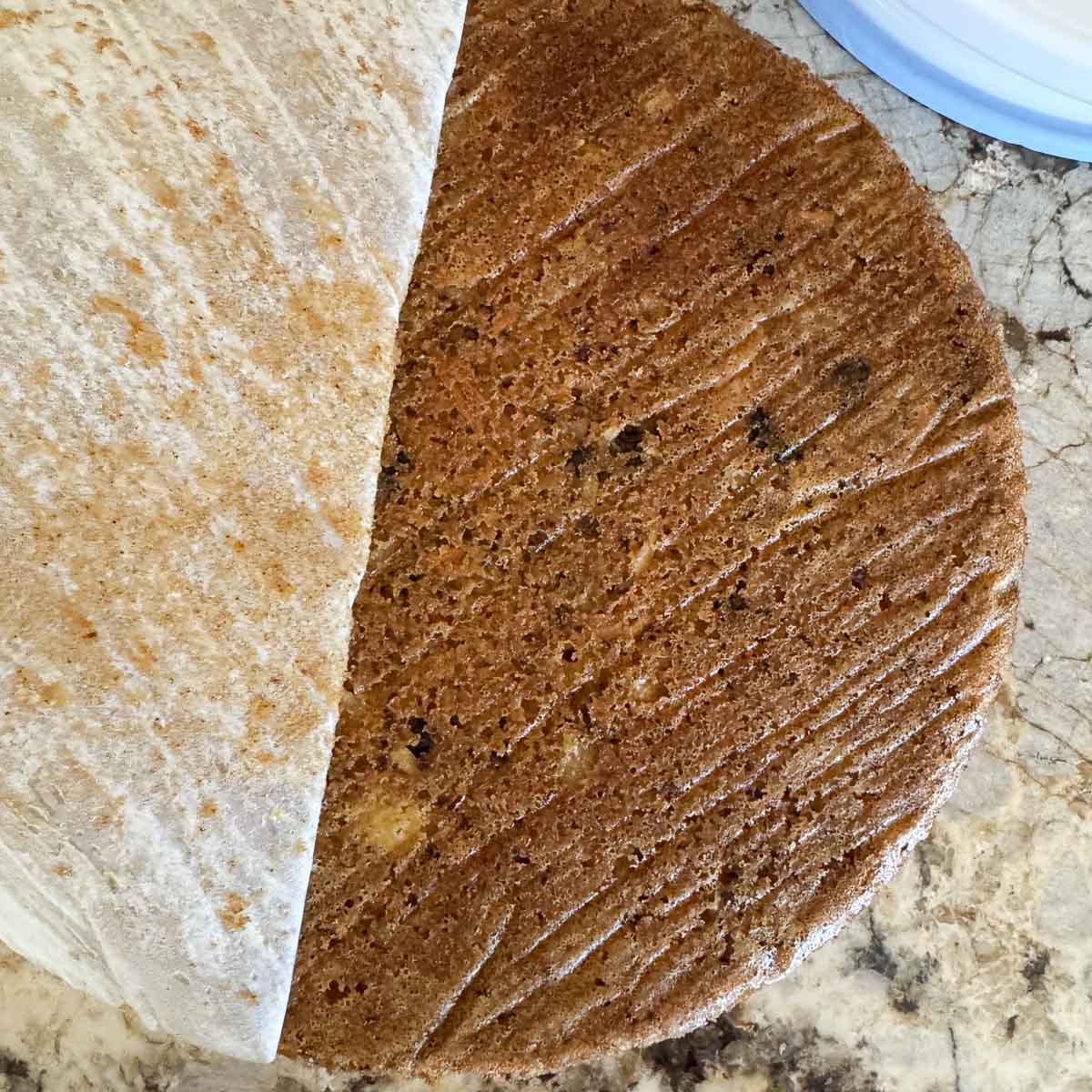pulling parchment papper from cake.