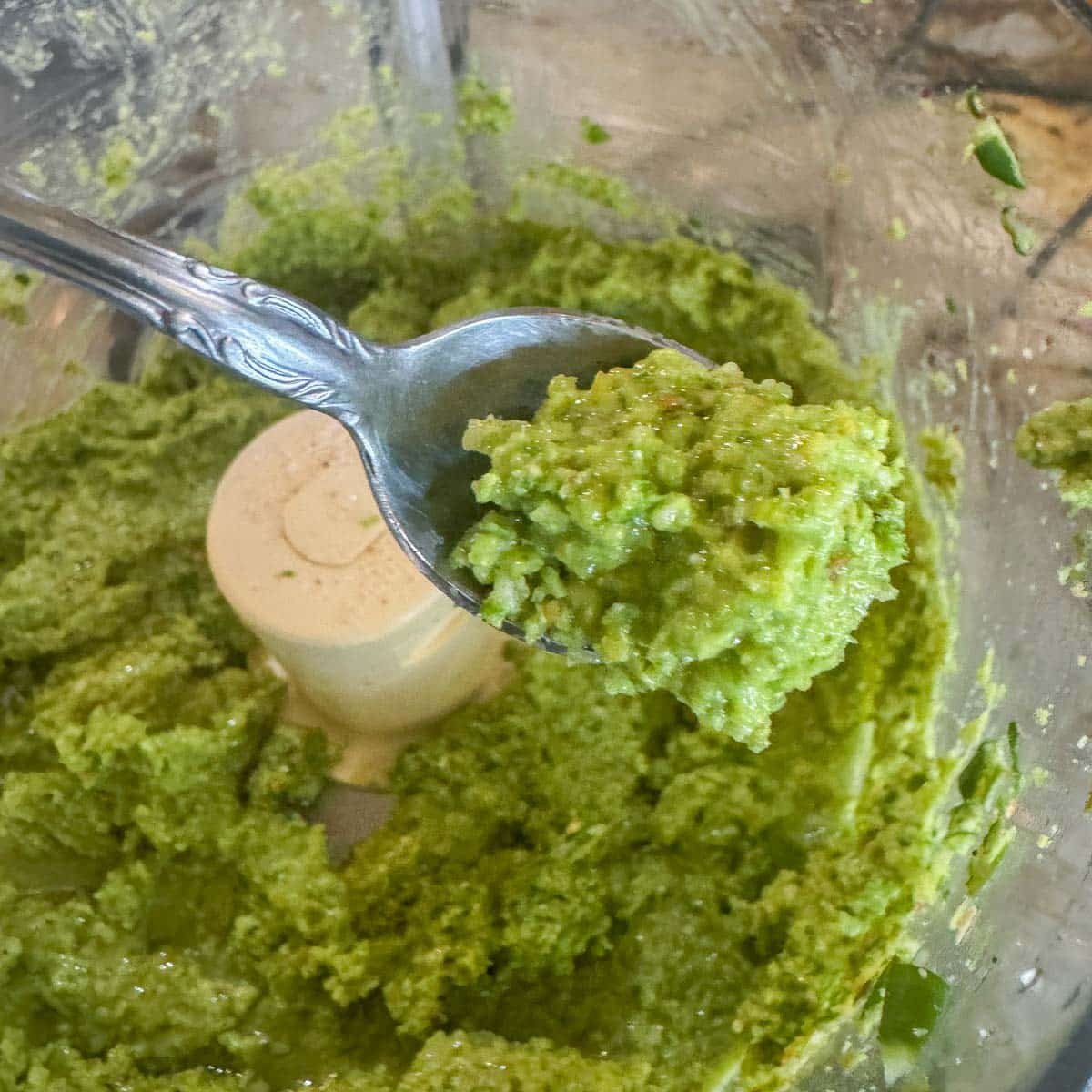 garlic scape pesto in a spoon. 