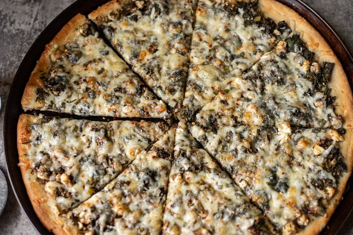 baked spinach and feta pizza .