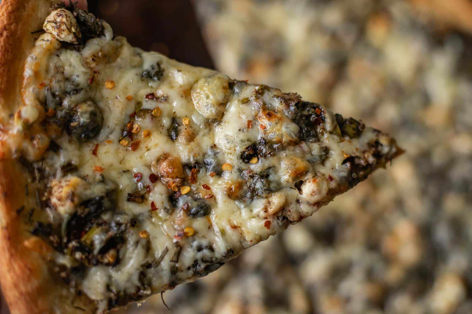 a slice of spinach and feta pizza.