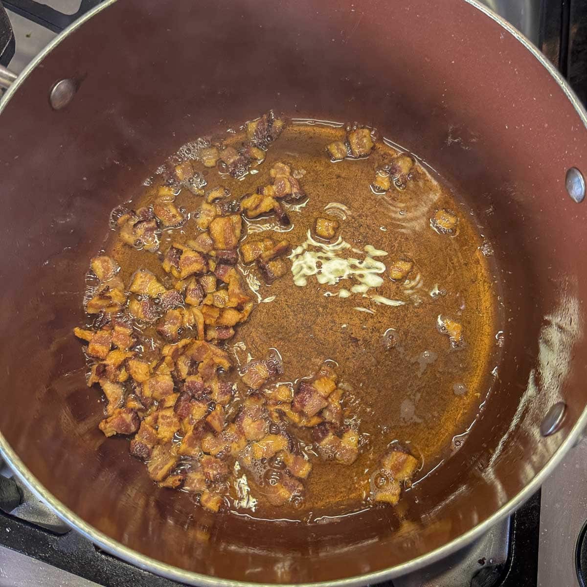 diced, fried bacon being fried. 