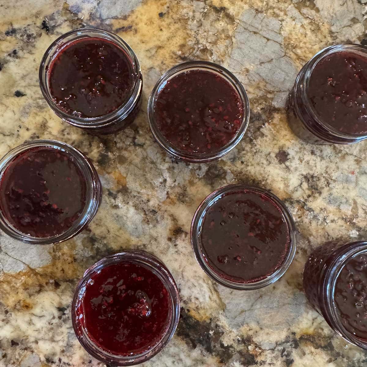jars of boysenberry jam without lids.