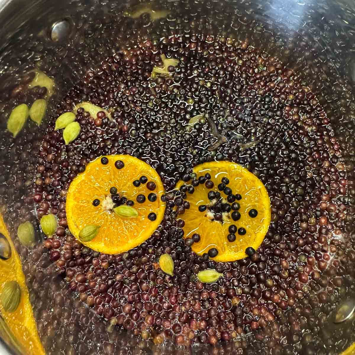 elderberry syrup simmering in a pot. 