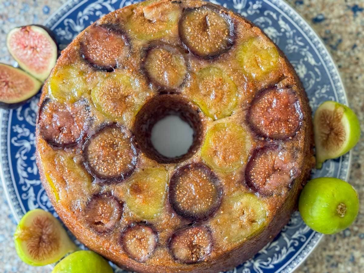 fig cake on a blue plate with figs around it.