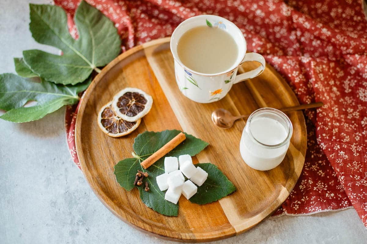 fig leaf tea on tray with ingredients and leaves after adding cream.