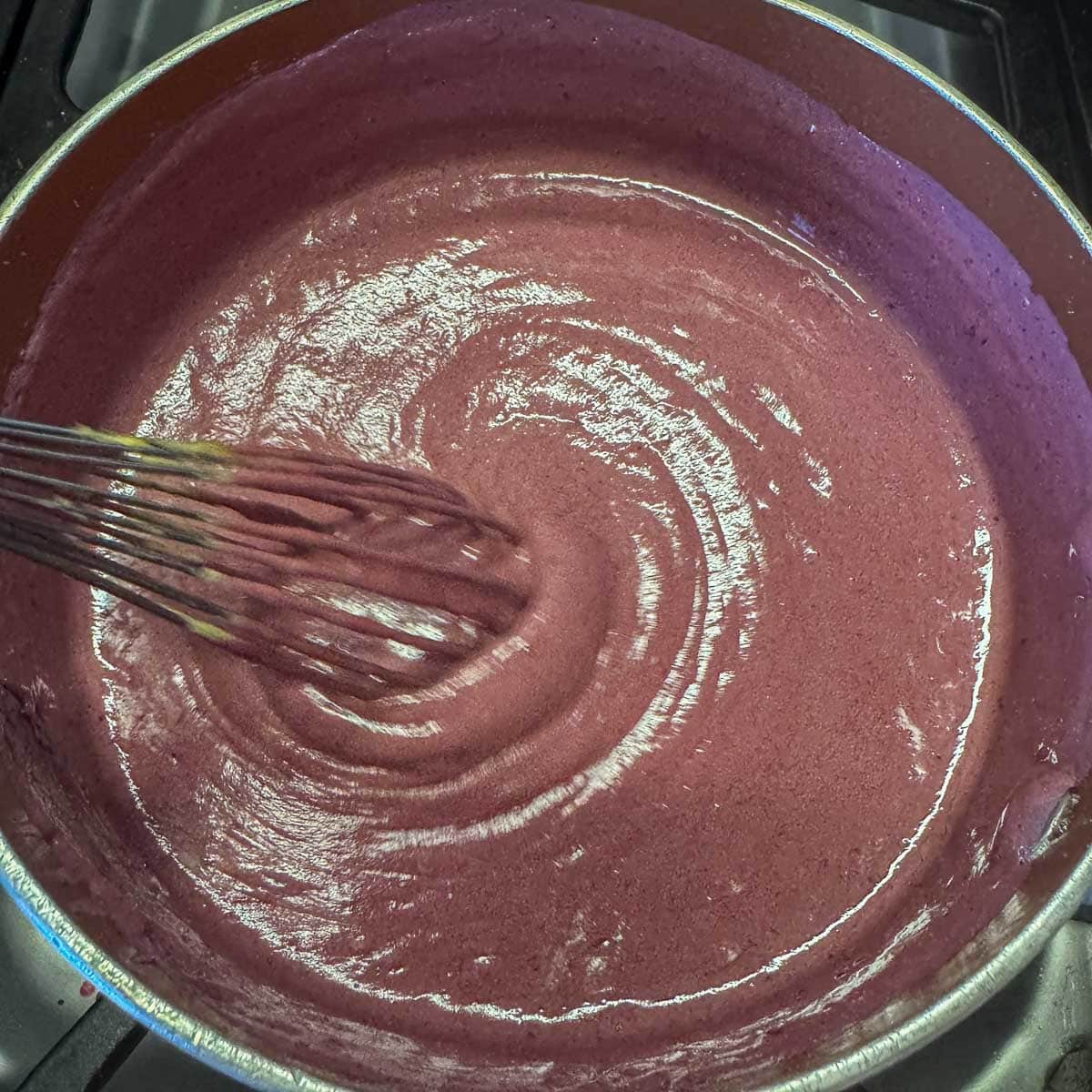 huckleberry curd cooking in a pot. 