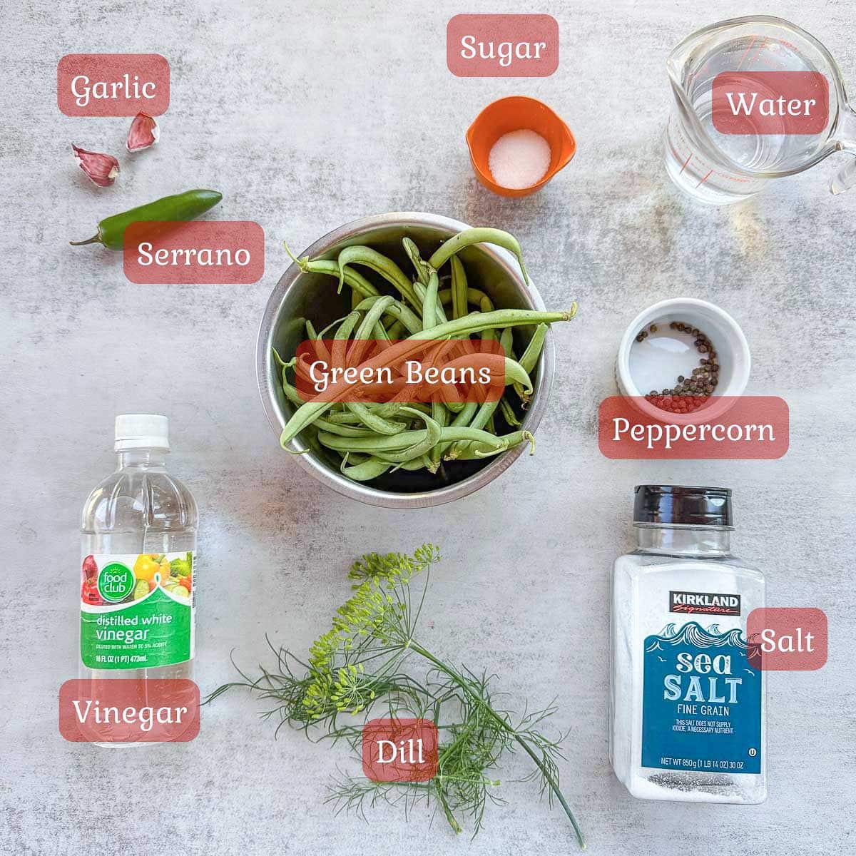 pickled green beans ingredients including green beans, herbs, vinegar, and salt. 