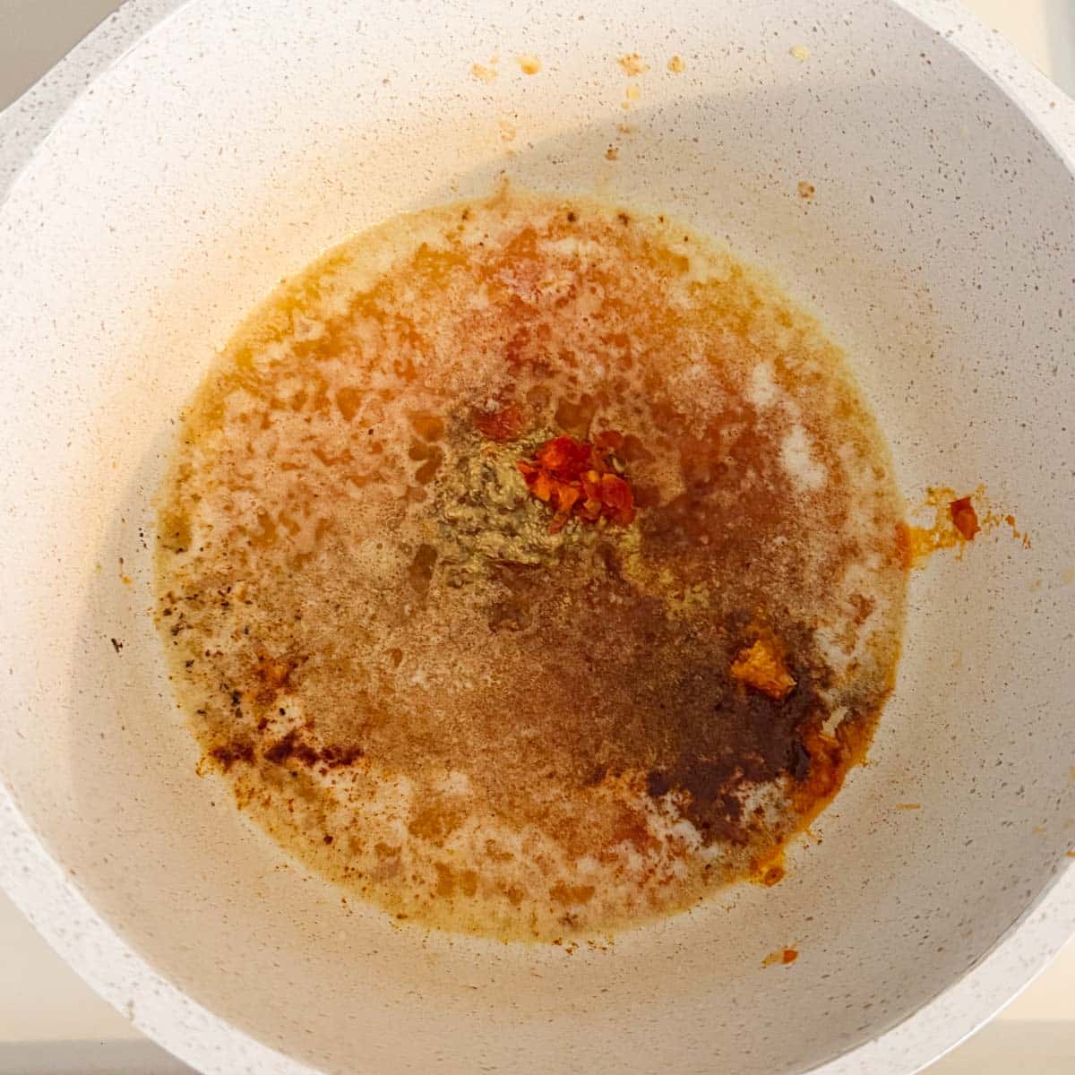 spices added to pot of melted butter before stirring.