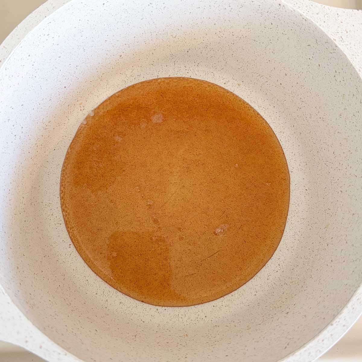 hot honey warming in pot.