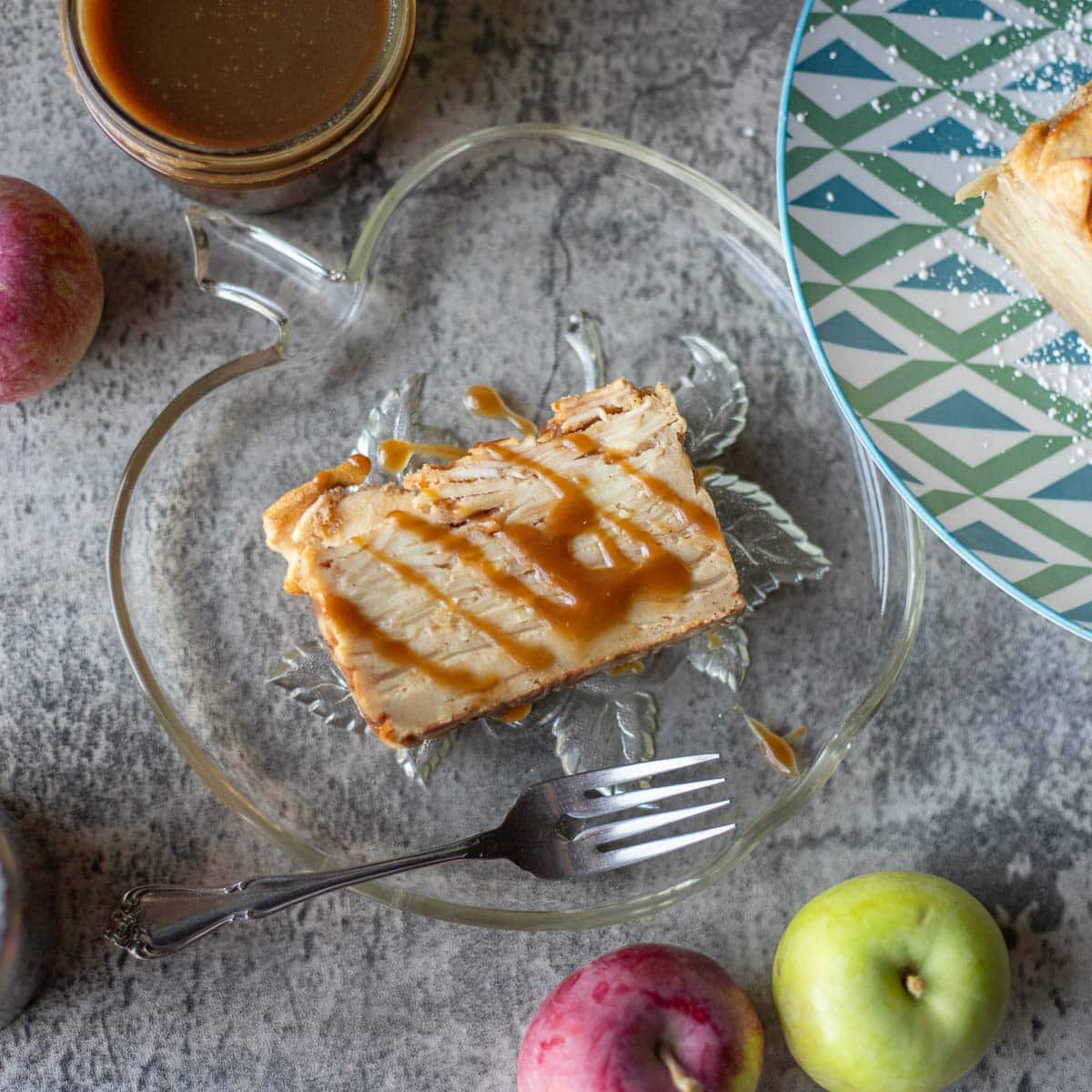 a slice of invisible apple cake with caramel drizzled over it.