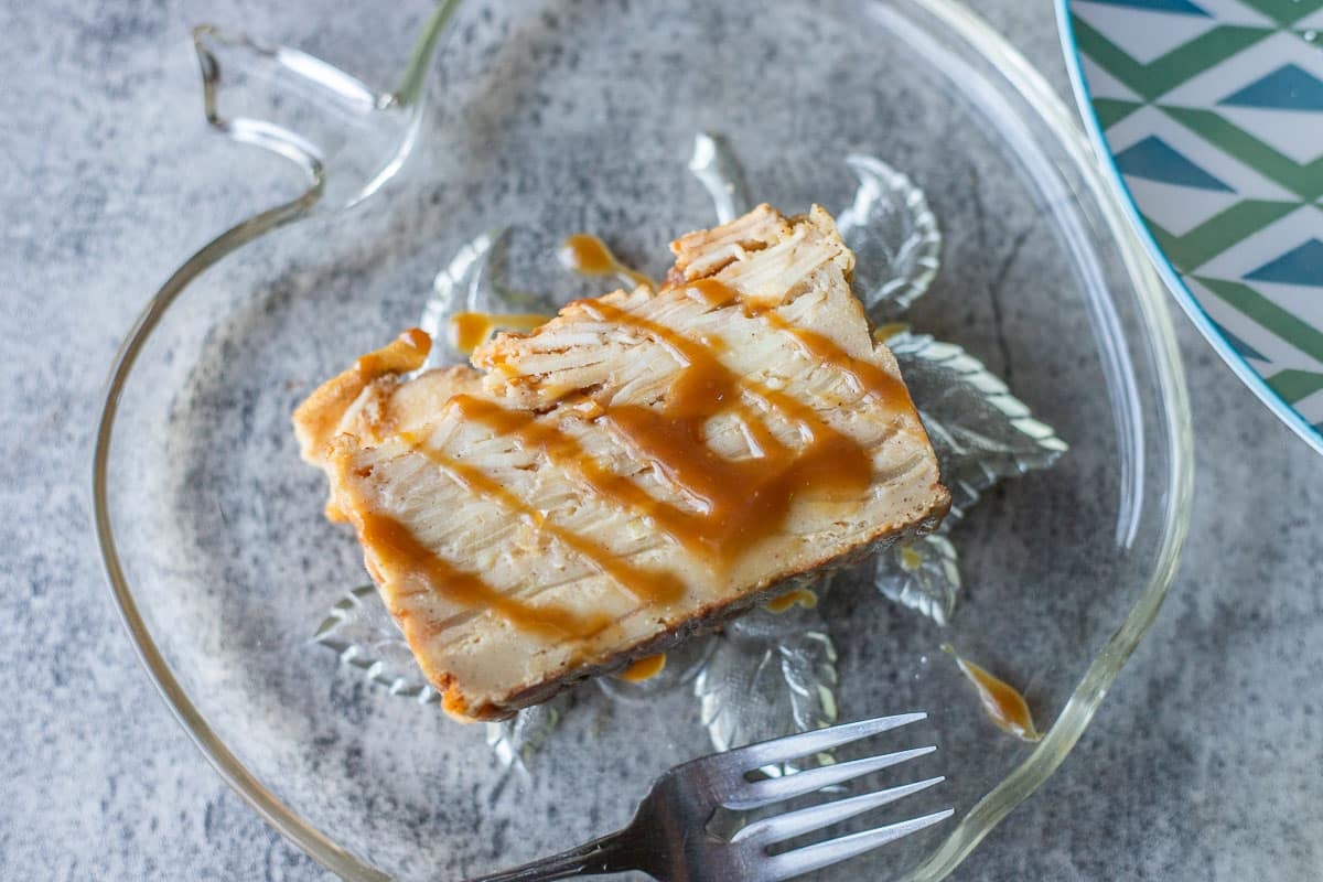 a slice of invisible apple cake on an apple shaped plate. 