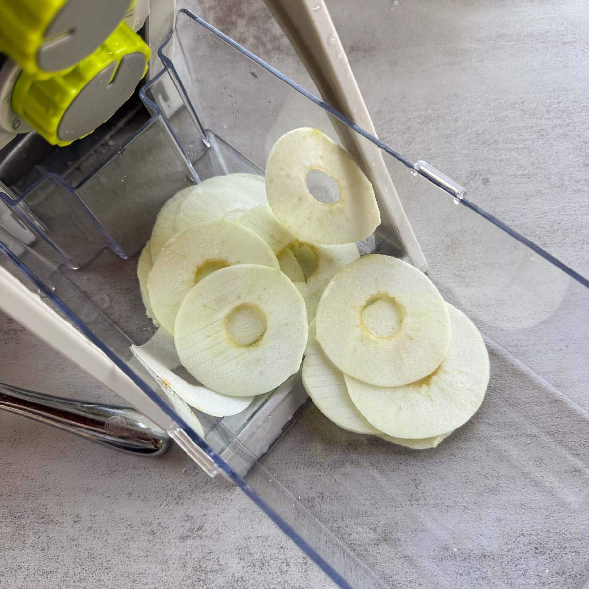 sliced apple in mandoline container. 