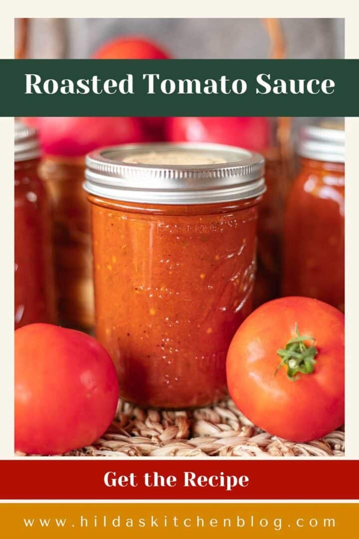 roasted tomato sauce in jars with tomatoes around it.