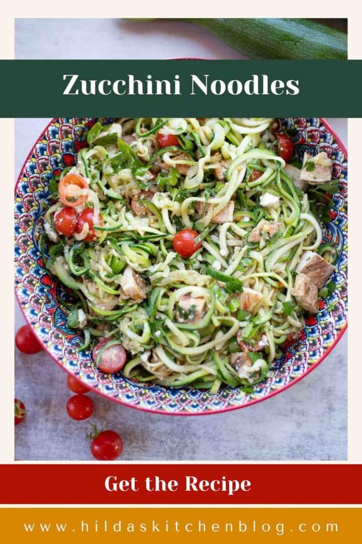 zucchini noodles dish with tomatoes and zucchini next to it.