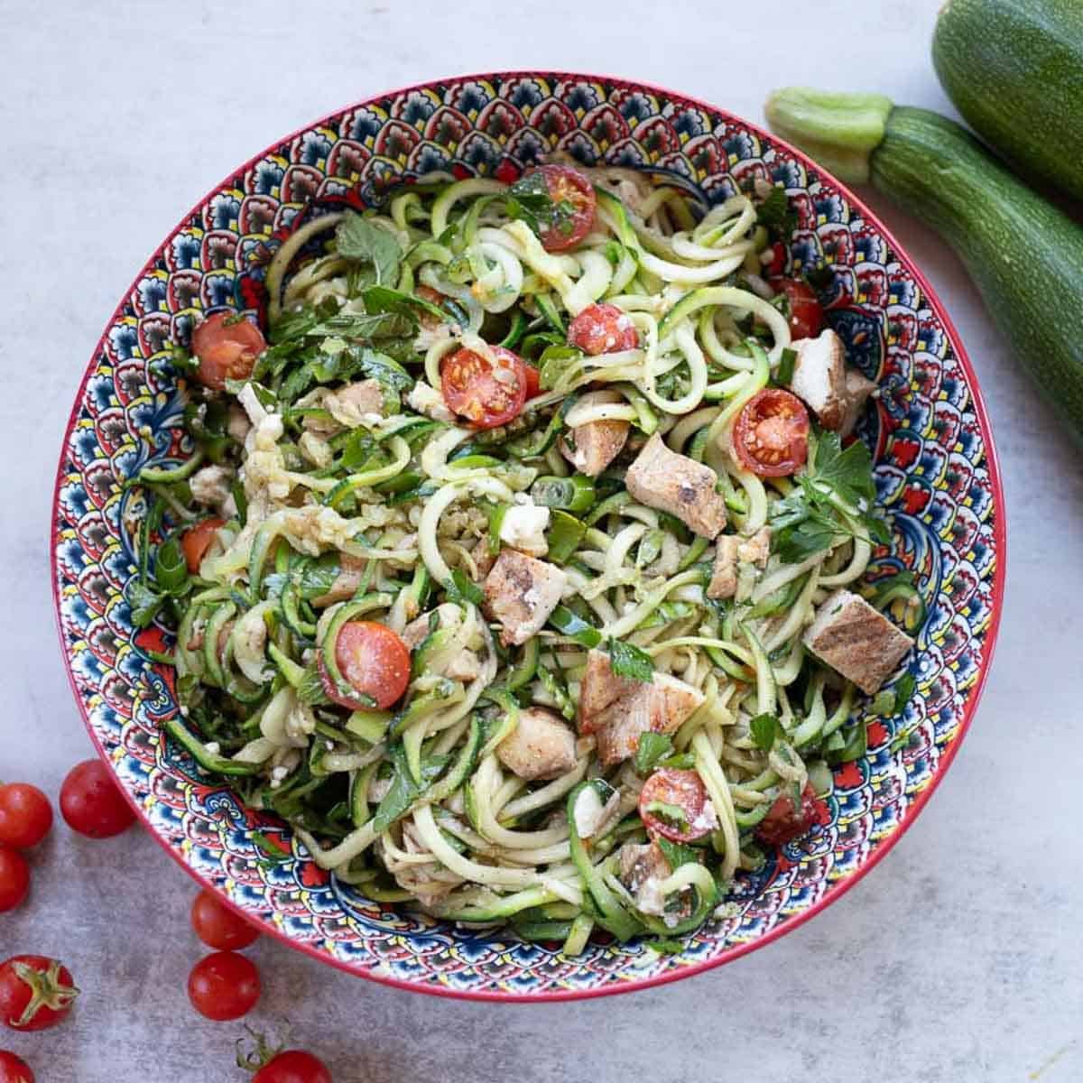 zucchini noodles recipe served in a colorful bowl.
