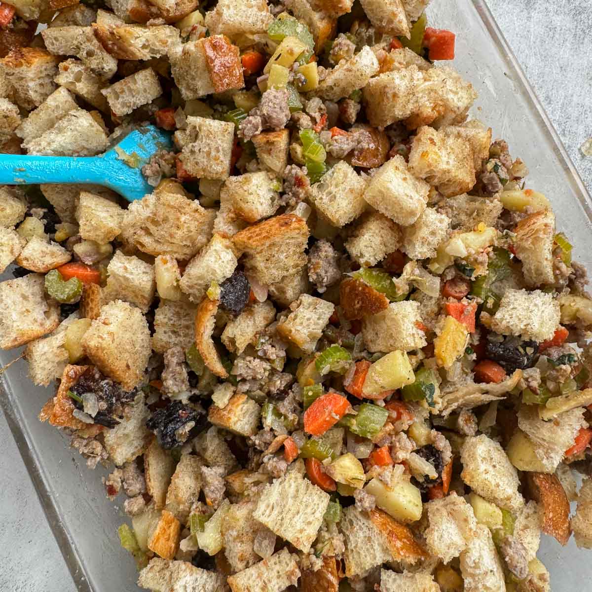 stirring cubed bread with stuffing mix. 