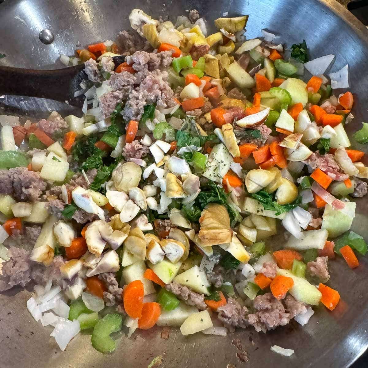 chestnut dressing veggies mix getting sauteed in a wok. 