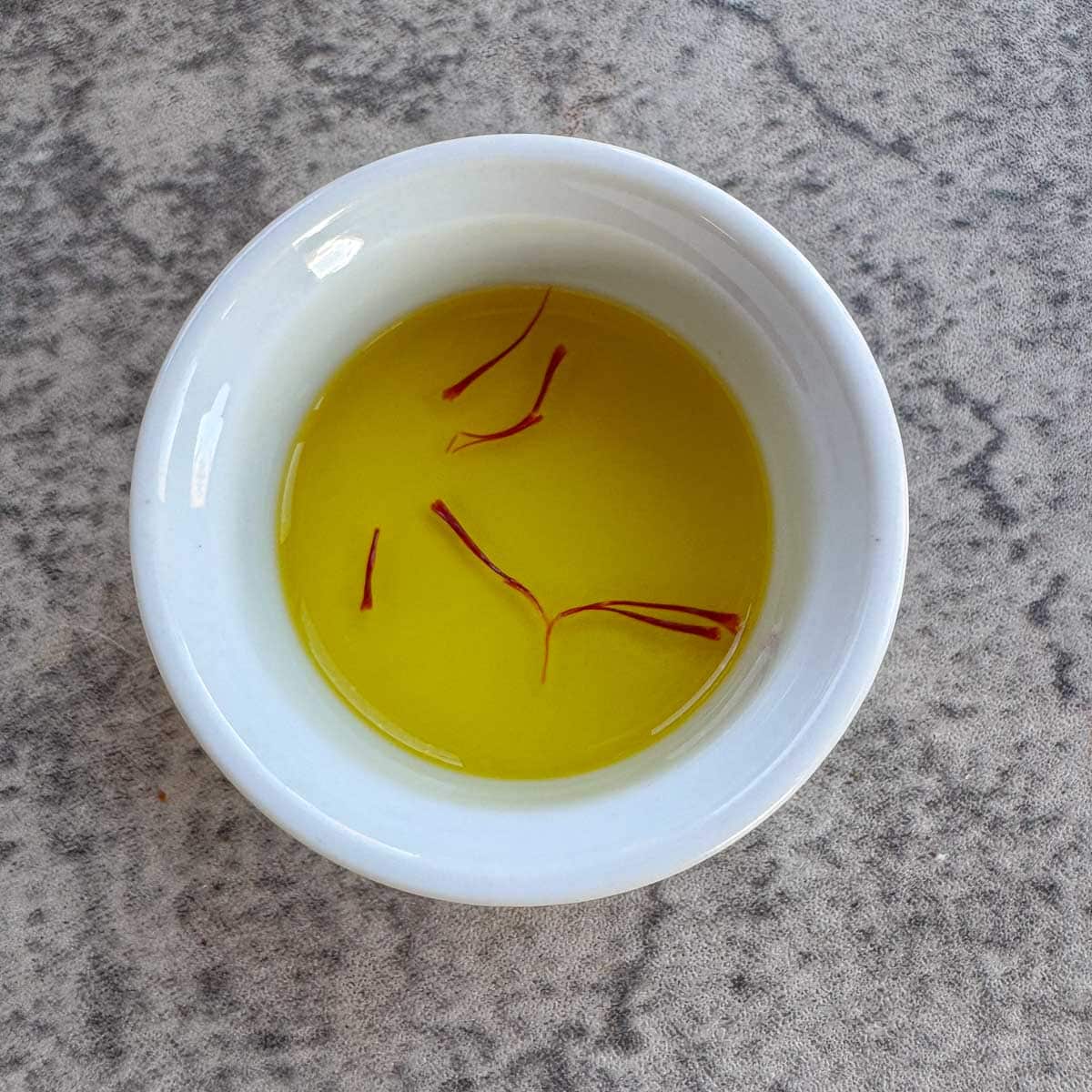 saffron threads blooming in a bowl of water.