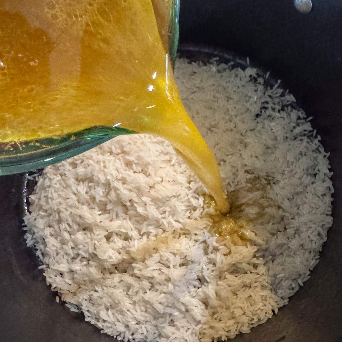 broth being poured over rice.