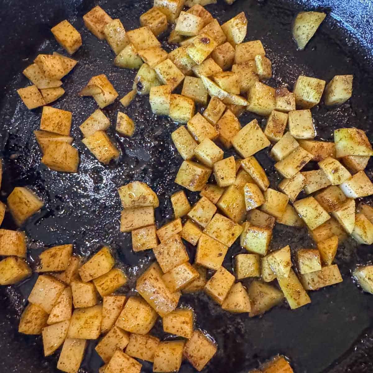 cubed potatoes in a pan.