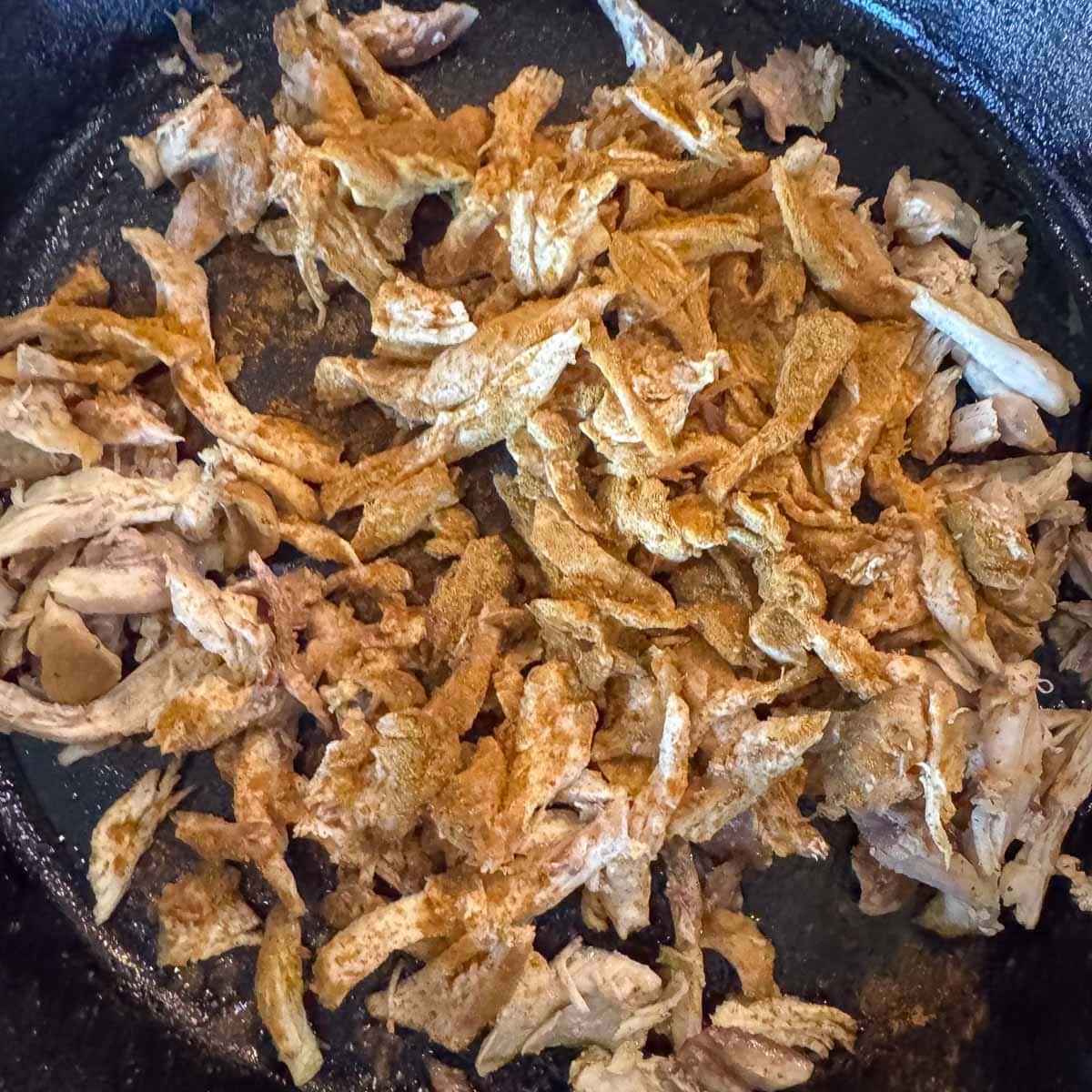 shredded chicken in a pan.