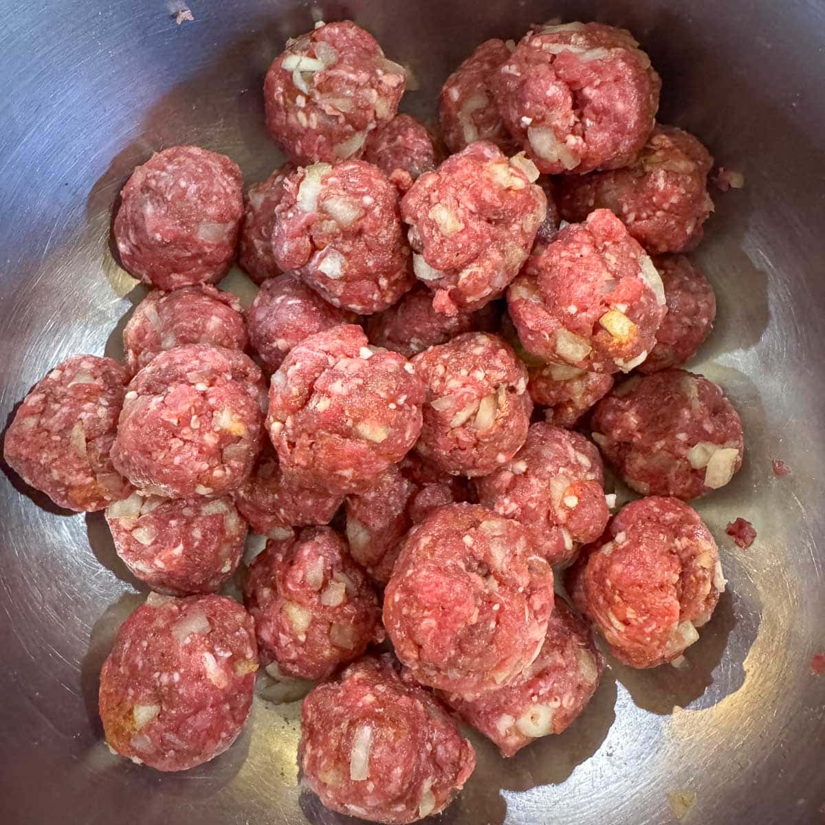 mini meatballs in a silver bowl.