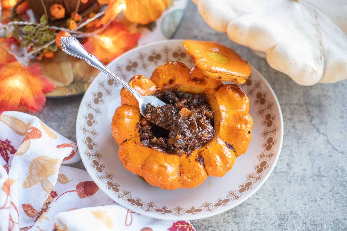 pattypan squash filled with meat and veggies with a white pattypan squash and a napkin with mushrooms.