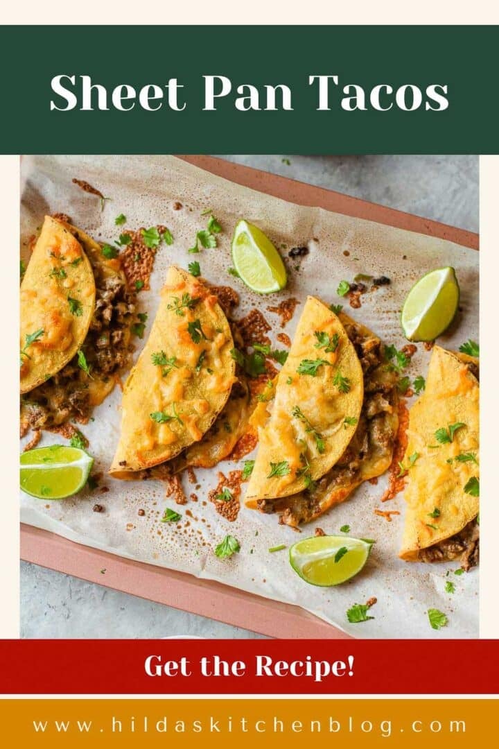sheet pan tacos topped with cilantro beside lime wedges.