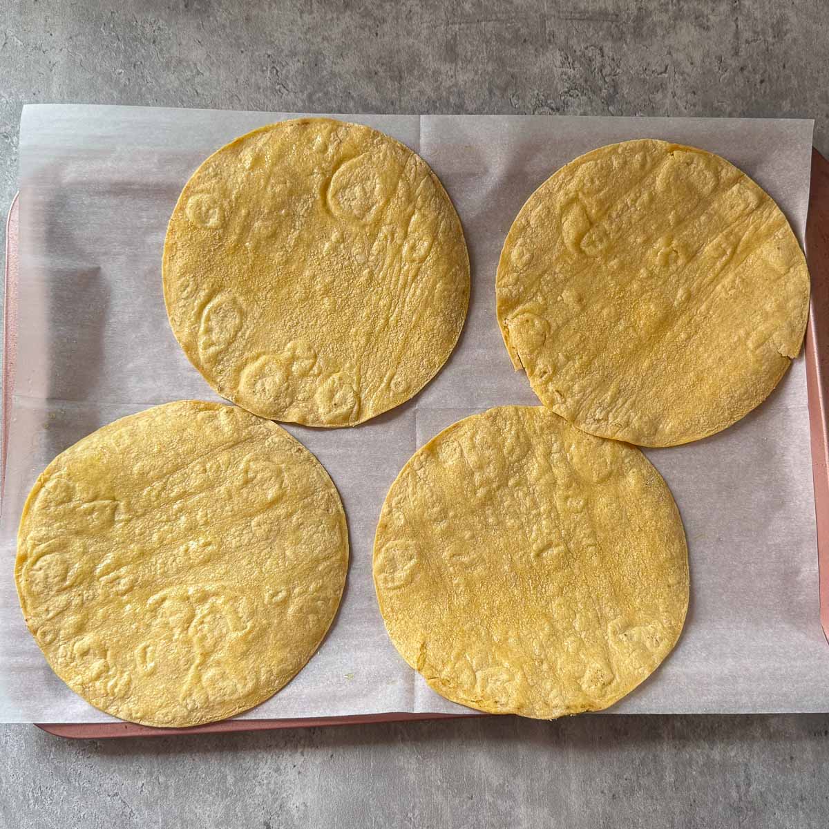 oiled tortillas on sheet pan.