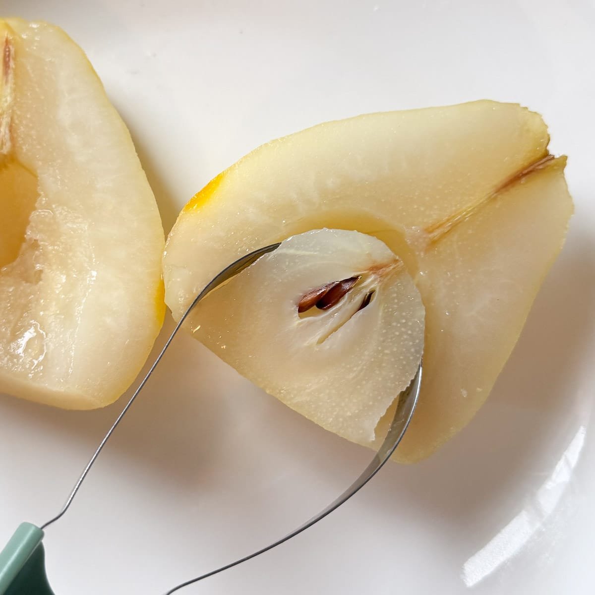fruit scoop removing pear core.