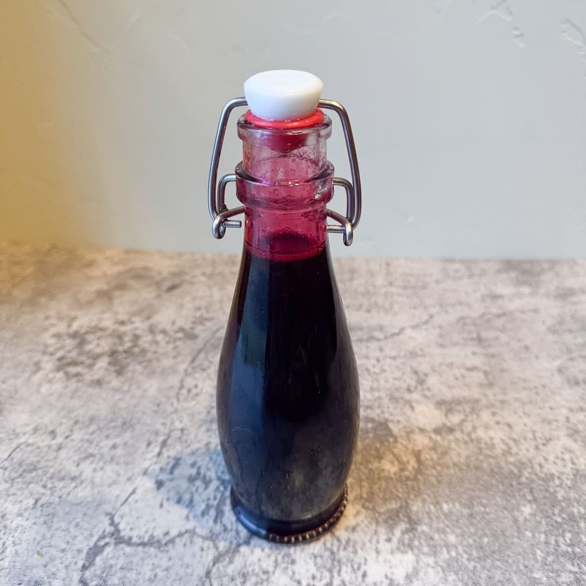 flip-top bottle full of pomegranate syrup.